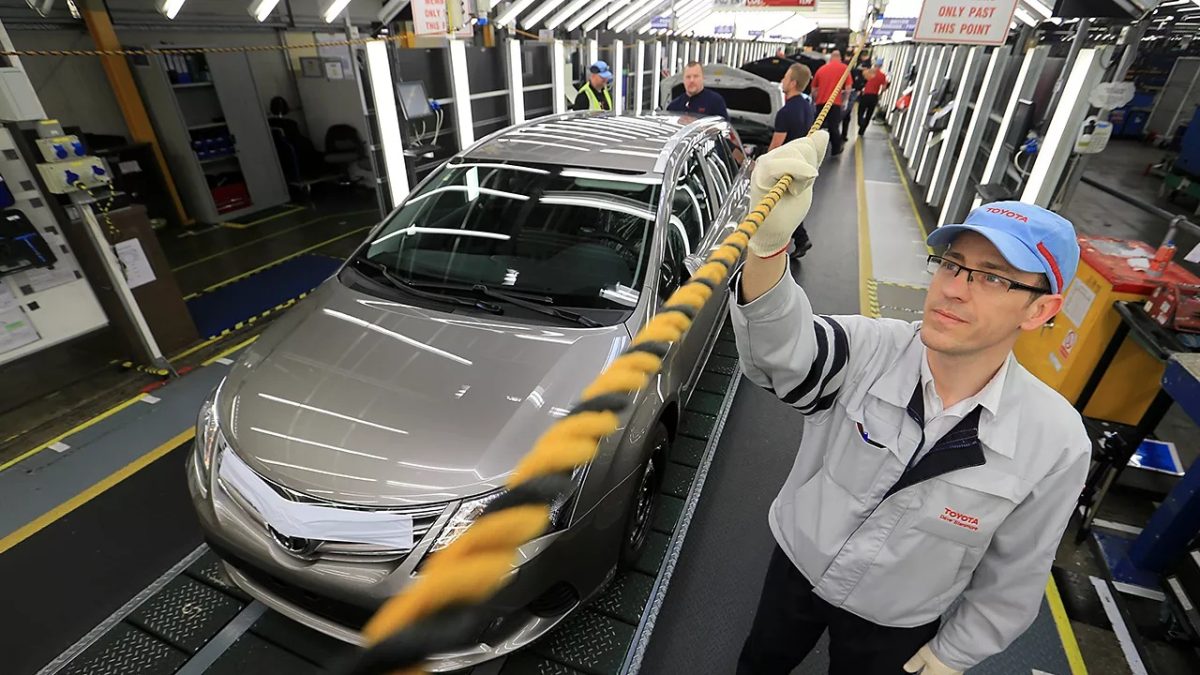 A Toyota line worker pulls the Andon Cord to stop the assembly line.